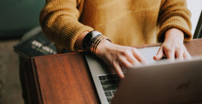 a person typing on a laptop